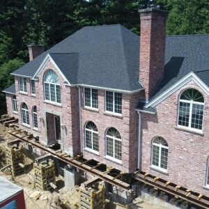 Aerial view of a brick house lifted from the foundation - Payne Construction Services