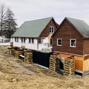 A house and garage lifted to create new foundation and walls - Payne Construction Services