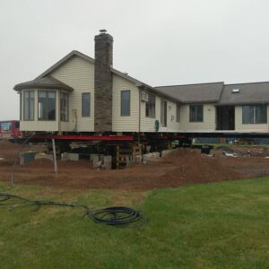 A house raised with steal beams and supported with beams for foundation repair - Payne Construction Services