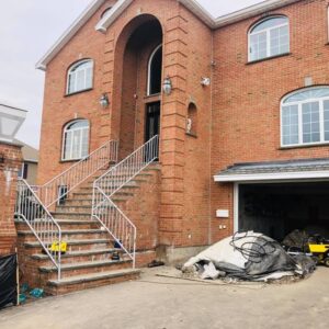 Outside of a brick building with construction materials - Payne Construction Services