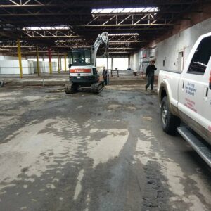 Team of contractors and their trucks working on a commercial project - Payne Construction Services
