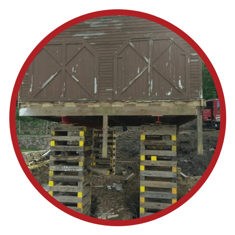 A historical barn is lifted up on piles.