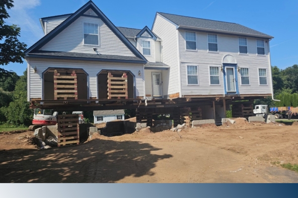 White home raised for foundation repair
