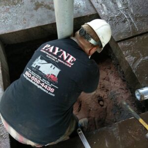 worker completing helical pilings