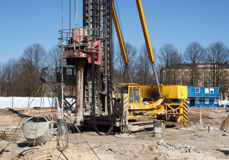 heavy machinery holding a spiral drill