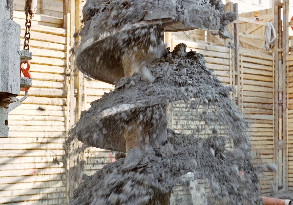 a large spiral drill digging up dirt