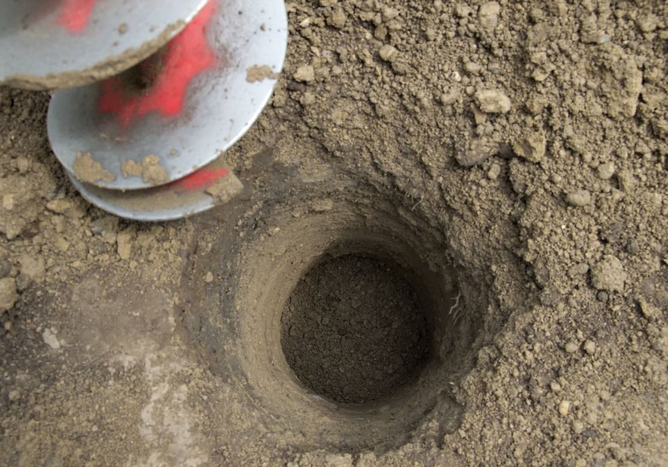 a spiral driller drilling a hole