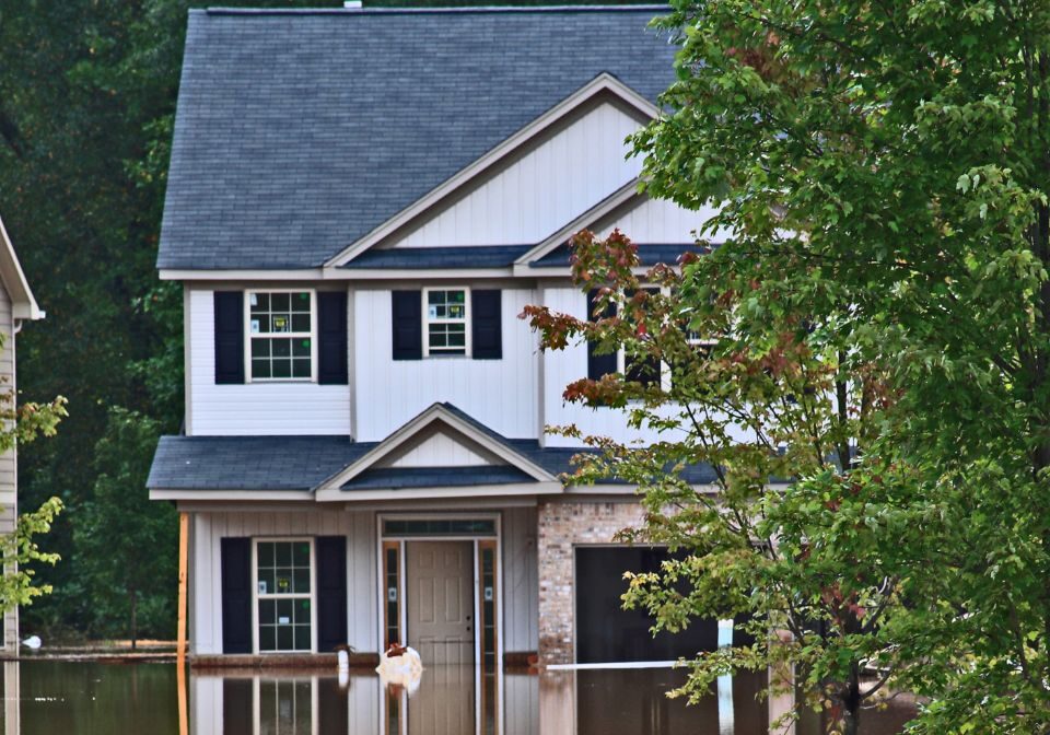 a two story home being flooded